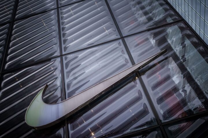 Nike-Logo an der Glasfassade eines Gebäudes.