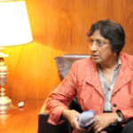 Navanethem Pillay sitzt in einem Sessel und hält Unterlagen in den Händen.