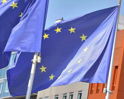EU-Flaggen vor einem modernen Gebäude im Wind.