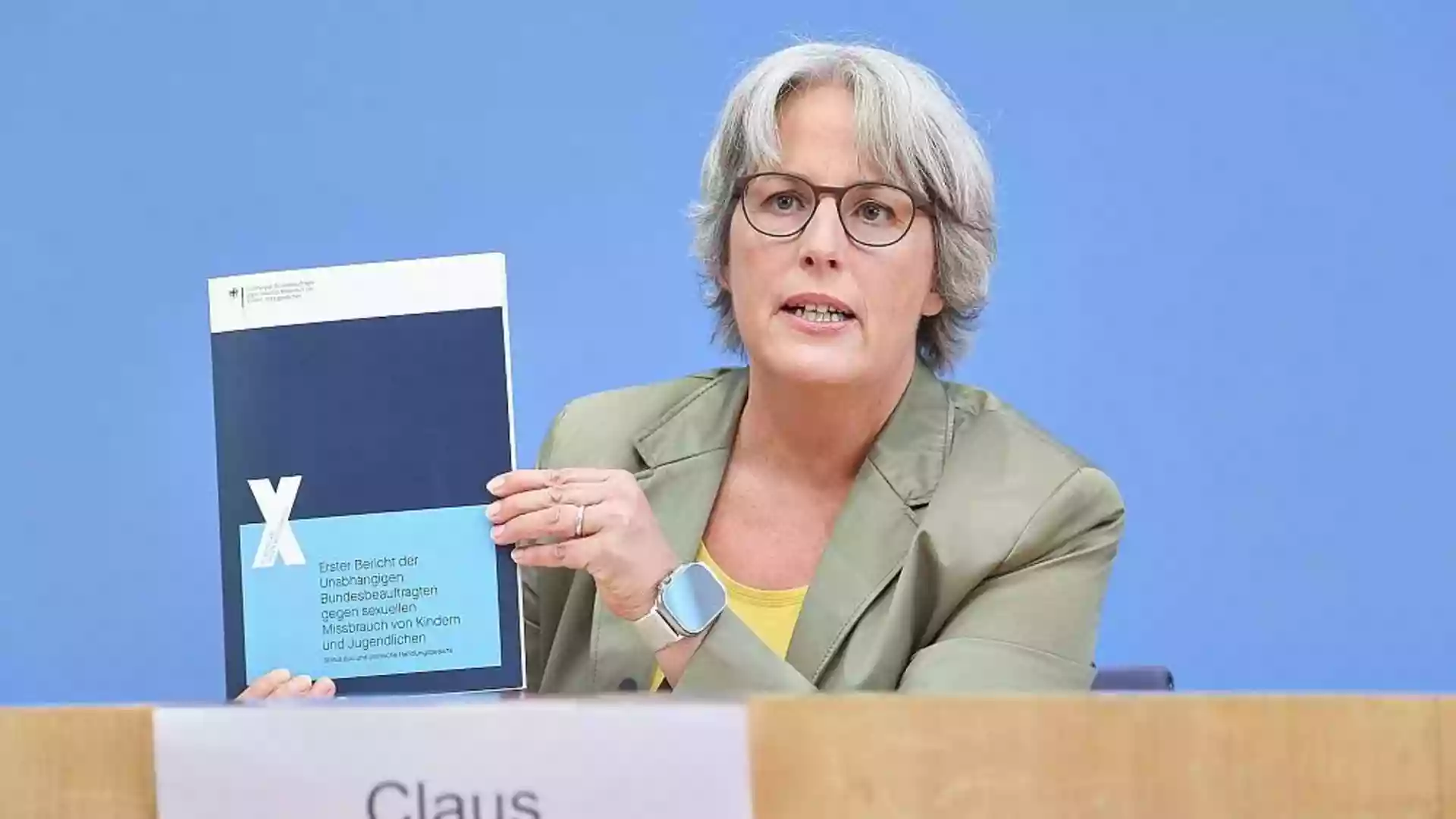 Claus legt ersten Bericht mit 15 Forderungen zum Kinderschutz vor 1 Kerstin Claus hält bei einer Pressekonferenz ihren Bericht zum Kinderschutz in die Kamera.