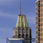 Ein Bank-of-America-Gebäude mit goldener Spitze vor blauem Himmel.
