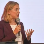 Verena Hubertz spricht mit einem Mikrofon bei einer Veranstaltung.